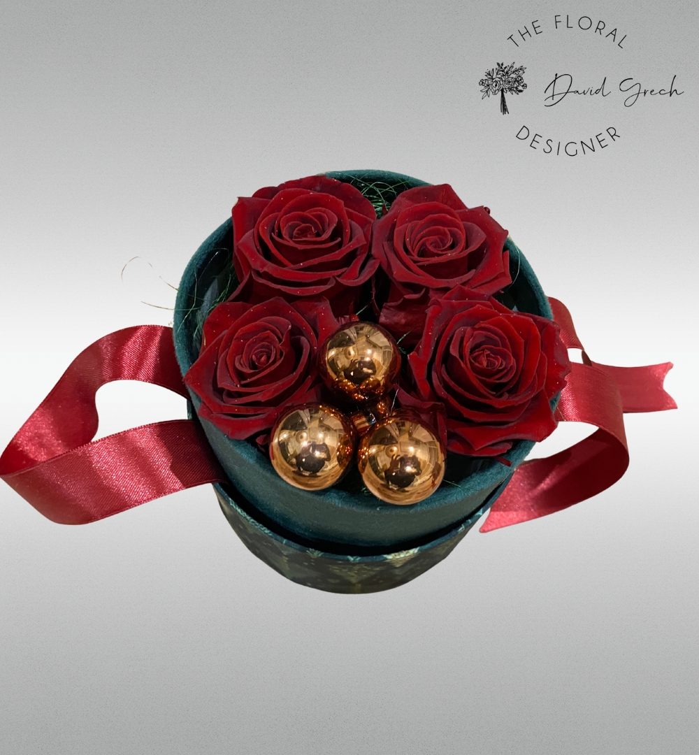 red preserved roses in an elegant hat box